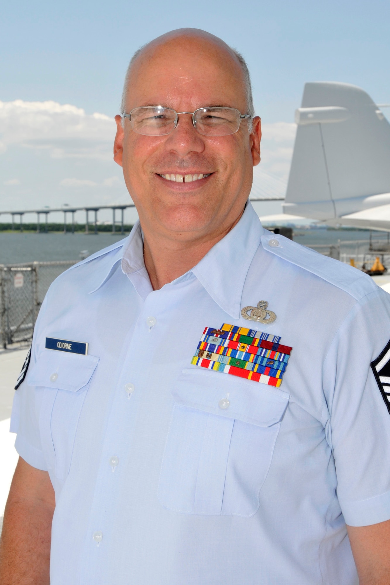 Master Sgt. Eric Odiorne, percussionist with the Air National Guard Band of the South, takes a minute to pose for a photo on the flight deck of the USS Yorktown, anchored in Mt. Pleasant, S.C., July 1, 2014. Odiorne performed the final concerts of his 24-year military career during the bands 2014 summer concert series. (U.S. Air National Guard photo by Senior Master Sgt. Paul Mann/Released)
