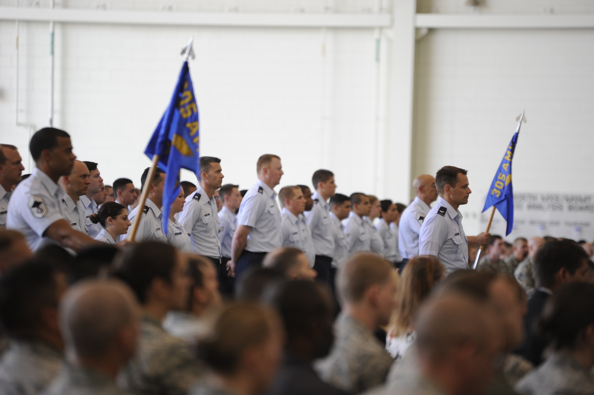 A formation of 305th Air Mobility Wing members stands at parade rest during the change of command ceremony July 11, 2014, at Joint Base McGuire-Dix-Lakehurst, N.J. The 305th AMW provides U.S. military combatant commands with global reach by rapidly generating, mobilizing and deploying 32 KC-10 and 13 C-17 aircraft to conduct strategic airlift and air refueling missions worldwide.  (U.S. Air Force photo by Airman 1st Class Sean M. Crowe/Released)