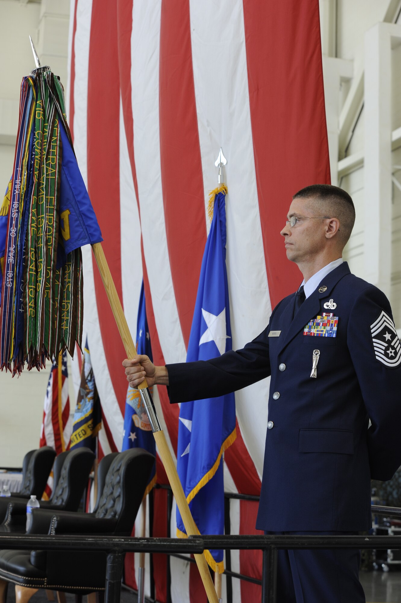 Chief Master Sgt. Daniel R. North , 305th Air Mobility Wing command chief, holds the unit guidon prior to the change of command ceremony July 11, 2014,  at Joint Base McGuire-Dix-Lakehurst, N.J. The 305th AMW provides U.S. military combatant commands with global reach by rapidly generating, mobilizing and deploying 32 KC-10 and 13 C-17 aircraft to conduct strategic airlift and air refueling missions worldwide.  (U.S. Air Force photo by Airman 1st Class Sean M. Crowe/Released)