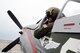 Larry Lumpkin, pilot of the P-51 Mustang, dons his helmet and flight suit for a media photo shoot at the Council Bluffs Municipal Airport, Iowa, on June 27.  The municipal airport is home to one of the many Commemorative Air Force hangars across the country that house vintage aircraft.  (U.S. Air Force photo by Josh Plueger/Released)