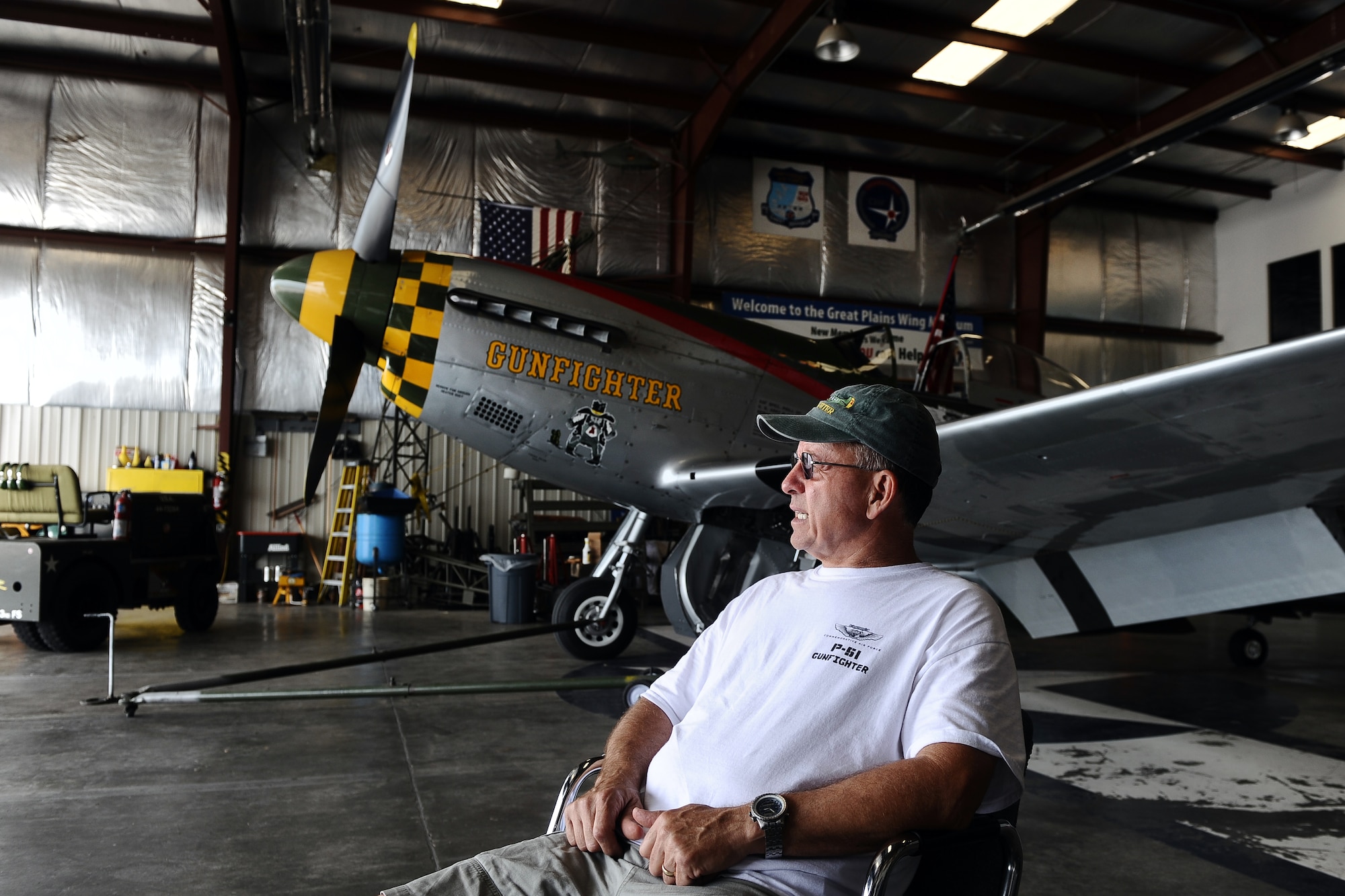 Larry Lumpkin, the current caretaker and pilot of the P-51 Mustang, sits down for an interview about his aviation career inside of the Commemorative Air Force hangar at the Council Bluffs Municipal Airport, Iowa, on June 27. Lumpkin adopted the role of pilot and caretaker of the Mustang from retried Brig. Gen. Regis Urschler, former 55th Strategic Reconnaissance Wing commander.  (U.S. Air Force photo by Josh Plueger/Released)