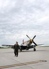 Larry Lumpkin, a P-51 Mustang pilot, keeps an eye on the changing weather overhead as he walks away from the aircraft he just rolled out of the hangar at the Council Bluffs Municipal Airport, Iowa, on June 27. Lumpkin has been the pilot of the P-51 for the past eight Defenders of Freedom Open House and Air Shows at Offutt.  (U.S. Air Force photo by Josh Plueger/Released)