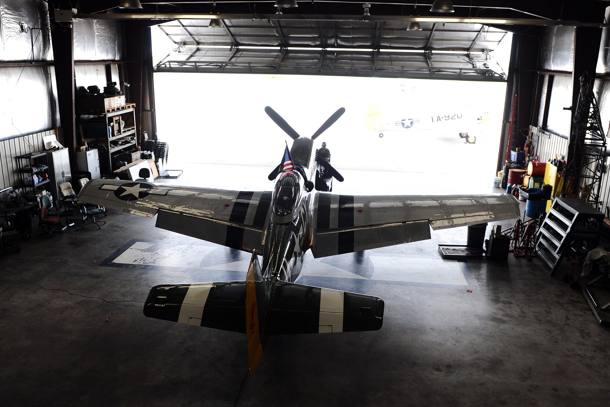 The P-51 Mustang Gunfighter sits inside the Commemorative Air Force hangar at the Council Bluffs Municipal Airport, Iowa, on June 27. The P-51 has been a marquee act at several air shows around the country for decades.  (U.S. Air Force photo by Josh Plueger/Released)