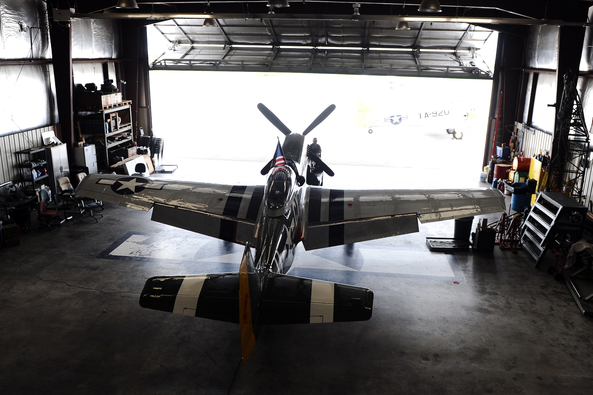 The P-51 Mustang Gunfighter sits inside the Commemorative Air Force hangar at the Council Bluffs Municipal Airport, Iowa, on June 27. The P-51 has been a marquee act at several air shows around the country for decades.  (U.S. Air Force photo by Josh Plueger/Released)