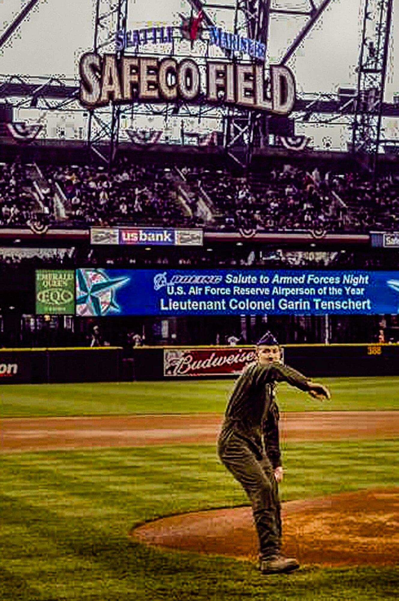 Col. Garin Tentschert, former 97th Airlift Squadron commander out of Joint Base Lewis-McChord, Washington, and Alaska Airlines captain, throws the opening pitch at the Seattle Mariners Salute to Armed Forces Night, April 2010. He's been flying aircraft with both organizations since 1999. In July 2014, he assumed Reserve a job with the Federal Emergency Management Agency, as an emergency preparedness liaison officer. (photo courtesy Ben VanHouten/Seattle Mariners)