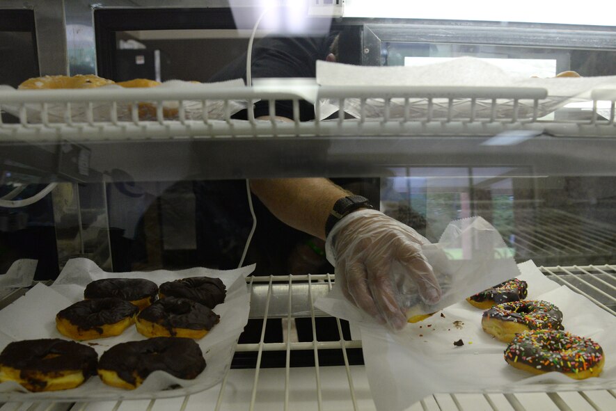 Mike Moser, Dark Cup O’ Joe store associate, packs up doughnuts to fill an order for a customer in the coffee shop, Sumter, S.C., July 3, 2014. Moser has been working at the coffee shop for a few months. (U.S. Air Force photo by Airman 1st Class Diana M. Cossaboom/Released)