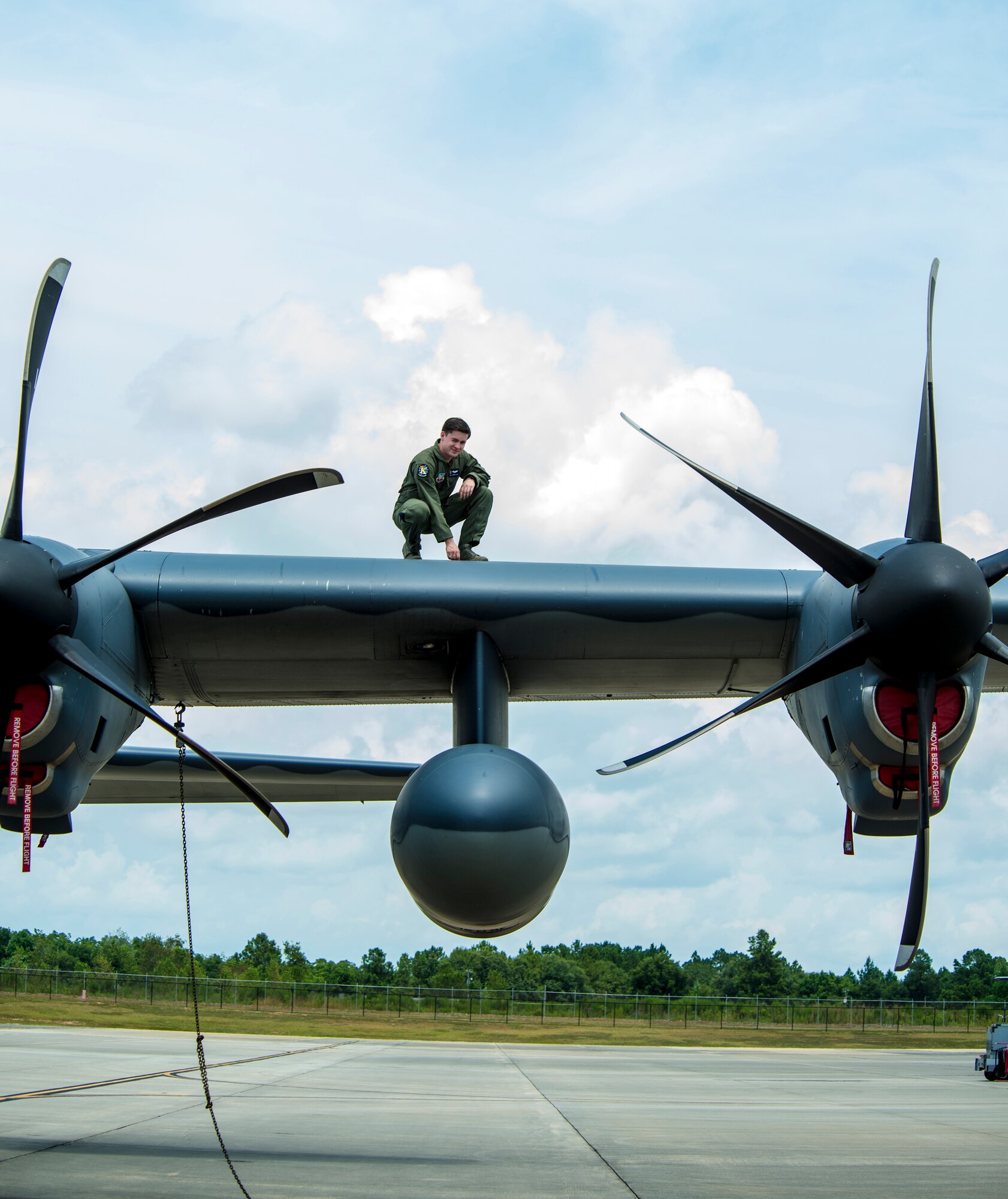 U.S. Air Force Senior Airman Todd Johnson,  71st Rescue Squadron HC-130J Combat King II loadmaster, kneels on the wing of an HC-130J to check for  flexibility at Moody Air Force Base, Ga., July 11, 2014. Flexibility is necessary to allow the wings to move while in flight. 
(U.S. Air Force photo by Airman 1st Class Ceaira Tinsley/Released)
