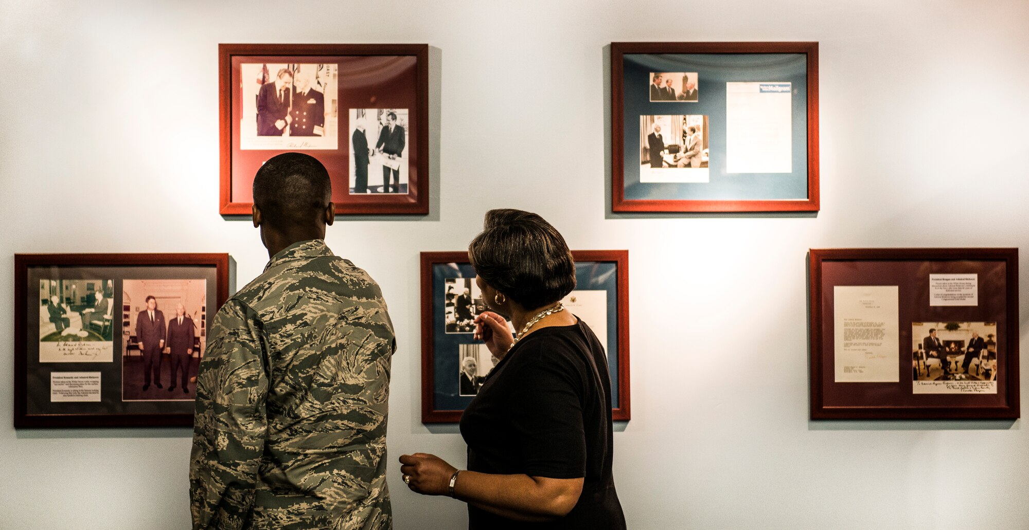 Gen. Darren McDew, Air Mobility Commander commander, and his wife, Evelyn, look at photos on the wall inside the Naval Nuclear Power Training Command building, July 10, 2014, at Joint Base Charleston, S.C. McDew visited JB Charleston to get a firsthand look at how joint basing builds closer relationships and forges stronger ties between our sister services. (U.S. Air Force photo/Senior Airman Dennis Sloan)