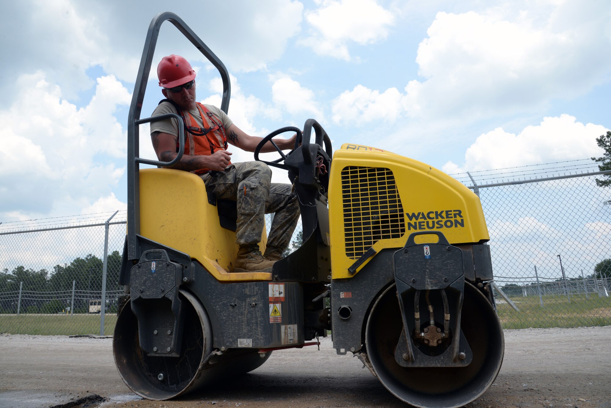 An 823rd Rapid Engineer Deployable Heavy Operational Repair Squadron Engineers Airman uses a Wacker Neuson one-ton mini steel wheel roller to smooth out a section of Patrol Road at Shaw Air Force Base, S.C., July 10, 2014. The roller uses a 47-inch front drum that vibrates as it rolls over fresh asphalt to give the road a smooth surface. (U.S. Air Force photo by Airman 1st Class Jonathan Bass/Released)
