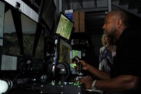 Kelvin Boone, 502nd Air Base Wing honorary commander, takes to the virtual sky via flight simulator at the Joint Base San Antonio-Randolph Trainer Development Squadron July 2, 2014. The Honorary Commander Program is intended to educate those with limited knowledge about the military or the installation while building relationships with members of the local community and encouraging those local civic leaders to share the Air Force story. (U.S. Air Force photo by A1C Stormy D. Archer/Released)