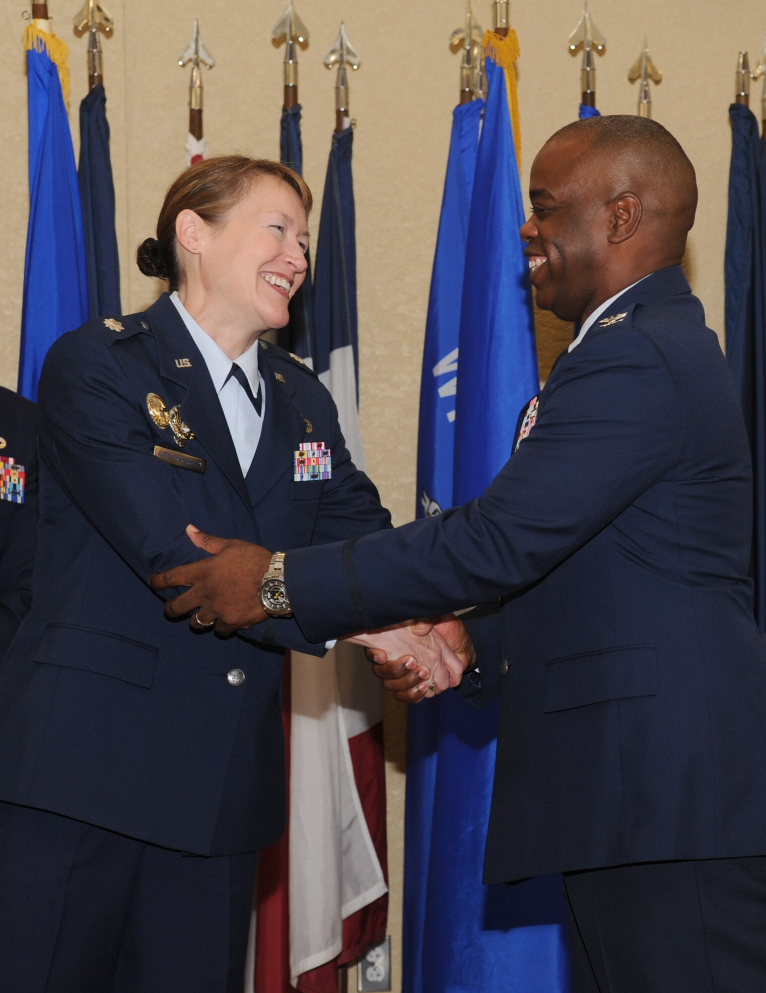 Lt. Col. Susan Airola-Skully, 81st Mission Support Group incoming commander, is congratulated by Col. Mark Vivians, outgoing commander, during the 81st MSG change of command ceremony July 10, 2014, at the Bay Breeze Event Center, Keesler Air Force Base, Miss. Airola-Skully was previously the deputy director, officer and enlisted personnel management, for the Under Secretary of Defense for Personnel and Readiness, Office of the Secretary of Defense, at the Pentagon.  Vivians will retire July 11.  (U.S. Air Force photo by Kemberly Groue)