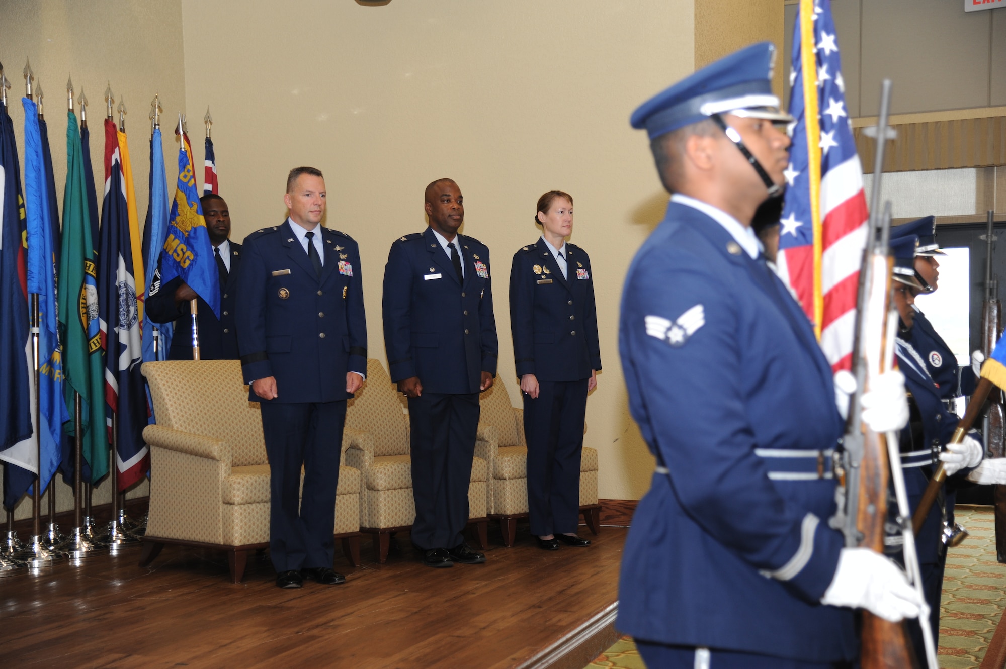 Brig. Gen. Patrick Higby, 81st Training Wing commander; Col. Mark Vivians, outgoing 81st Mission Support Group commander; and Lt. Col. Susan Airola-Skully, incoming 81st MSG commander, stand at attention as the Keesler Honor Guard presents the colors during the 81st MSG change of command ceremony July 10, 2014, at the Bay Breeze Event Center, Keesler Air Force Base, Miss.  Airola-Skully was previously the deputy director, officer and enlisted personnel management, for the Under Secretary of Defense for Personnel and Readiness, Office of the Secretary of Defense, at the Pentagon.  Vivians will retire July 11.  (U.S. Air Force photo by Kemberly Groue)