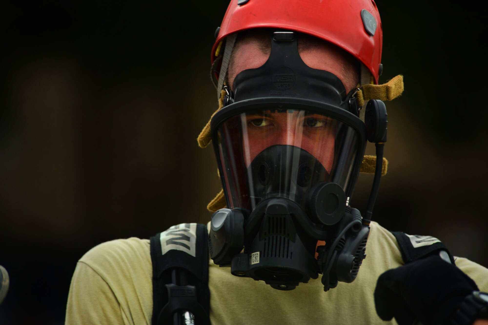 A 20th Civil Engineer Squadron firefighter prepares for hazardous material training at Shaw Air Force Base, S.C., July 11, 2014.  During the three step decontamination process, an Airmen steps through an initial decon, scrubbing and general rinse to become chemical free. (U.S. Air Force photo by Airman 1st Class Jensen Stidham/Released)