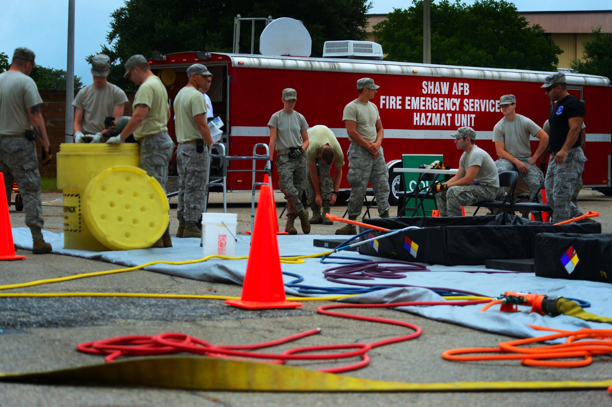 Airmen from the 20th Civil Engineer Squadron firefighters prepare to begin hazardous material decontamination training at Shaw Air Force Base, S.C., July 11, 2014.  The annual decontamination training was held over the course of two days, starting with classroom briefings and ending with a hands-on ‘walk through’ of the process. (U.S. Air Force photo by Airman 1st Class Jensen Stidham/Released)  