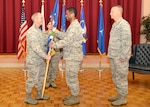 Brig. Gen. Bob LaBrutta (left), 502nd Air Base Wing and Joint Base San Antonio commander, passes the guidon to Col. Alexander Smith the incoming commander of the 502nd Installation Support Group in a change of command ceremony July 11, 2014 at the JBSA-Lackland Gateway Club. Outgoing 502nd ISG commander, Col. William Eger III (right) heads to Fort George G. Meade, Md. to serve as the deputy director of network services at the Defense Information Systems Agency. 