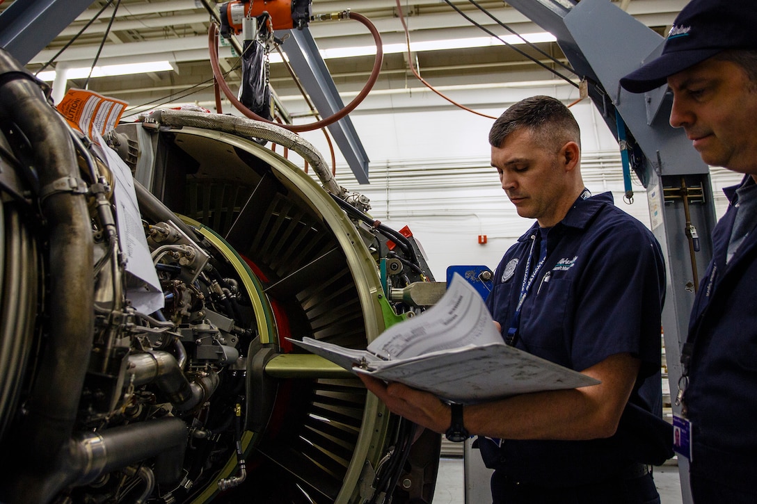 Senior Master Sgt. Marty Hitt, 446th Aircraft Maintenance Squadron, Blue Aircraft Maintenance Unit assistant superintendent at Joint Base Lewis-McChord, Washington, inspects a Boeing 737 aircraft engine with a coworker April 24, to ensure it’s at operational capability in his day job with Alaska Airlines. As a maintenance trainer for the airline, Hitt is responsible for the supplemental training for the Maintenance & Engineering division technicians. (U.S. Air Force Reserve photo by Jake Chappelle)