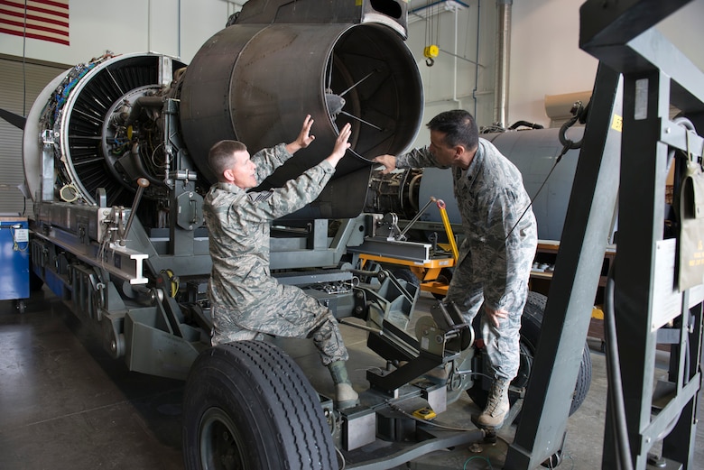 Master Sgt. Matthew Gardenhour, a propulsion specialist, explains parts on a F117 PW100 engine to Lt. Col. Christian Cunningham, deputy commander of the maintenance group, after leading a slide show presentation detailing the parts on the C-17 engine to Cunningham and members of the propulsion element, June 7. (Air National Guard photo by Master Sgt. Emily Beightol-Deyerle)