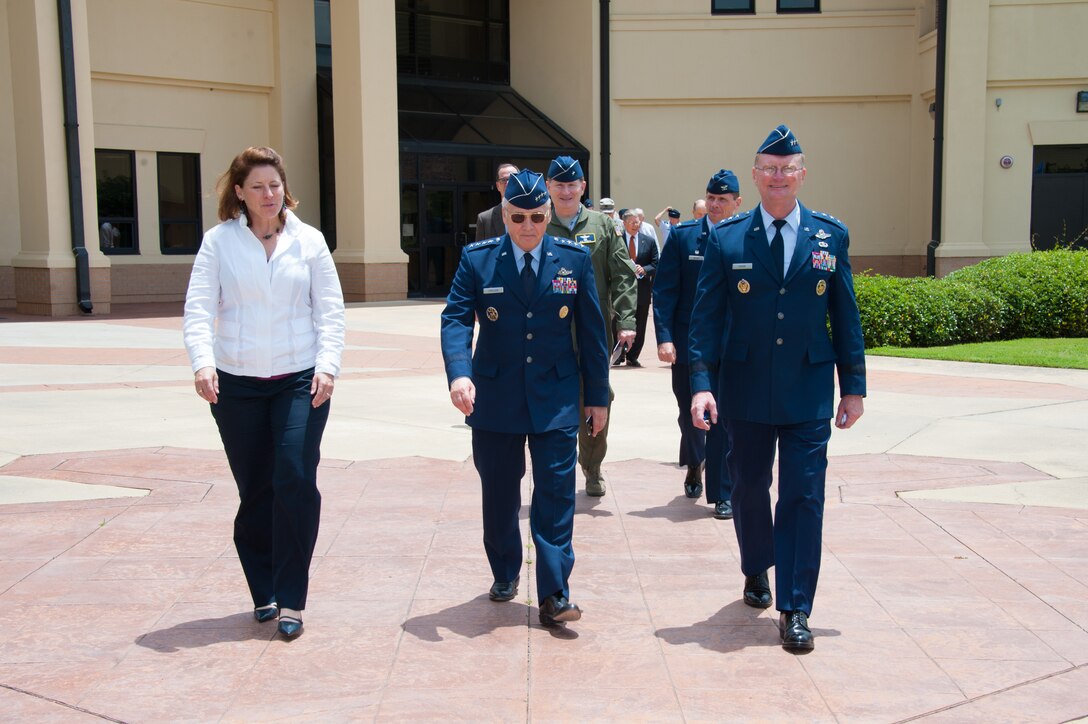 Gen. Bruce Carlson, (ret.) walks out of the Jeanne M. Holm Center For Officer Accessions and Citizen Development Officer Training School campus with Lt. Gen. David Fadok, his wife, and other members of the official party, after a ceremony for Carlson held at Maxwell, June 27, 2014. Carlson was selected to recive the Air Force Reserve Officer Training Corps Distinguished Alumni Award to commemorate his thirty seven years of exepmlary military service. (U.S. Air Force Photo by Staff Sgt. Gregory Brook) 