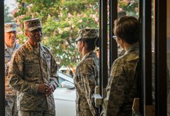 Gen. Darren McDew, Air Mobility Command commander, is greeted by Airmen from the 628th Force Support Squadron as he enters the Gaylor Dining Facility to eat breakfast July 10, 2014, at Joint Base Charleston, South Carolina. During the breakfast, McDew met with 20 junior servicemembers from various branches at JB Charleston to answer questions, solicit feedback and offer words of encouragement. (U.S. Air Force photo/ Airman 1st Class Clayton Cupit)