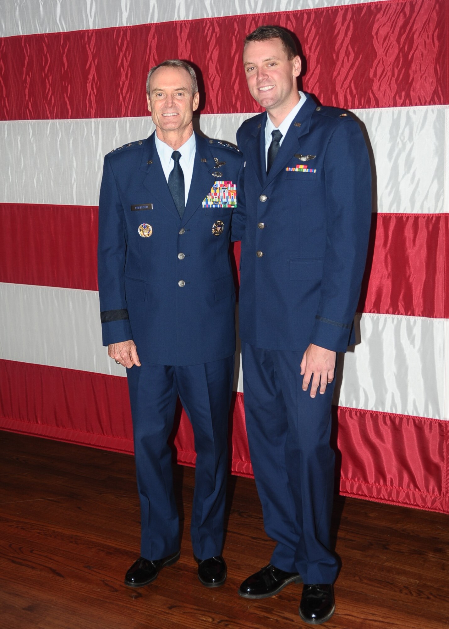 Lt. Gen. Darryl Roberson, Commander, 3rd Air Force and 17th Expeditionary Air Force, Ramstein Air Base, Germany, and his son 2nd Lt. Chad Roberson, pose for a photo after the graduation of class 14-11 July 3 at the Kaye Auditorium. Gen. Roberson not only spoke at his son’s graduation, but was also able to commission him as a second lieutenant just a year prior. (U.S. Air Force photo/ Airman John Day)