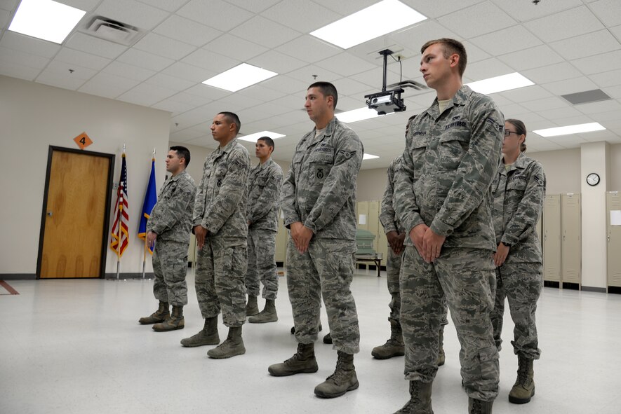 A base honor guard training class forms up to receive an end-of-day briefing July 9, 2014, at Moody Air Force Base, Ga. Ceremonial guardsmen here initially go through three weeks of full-time training to perfect their movements during their four- to six-month rotations. (U.S. Air Force photo by Airman 1st Class Sandra Marrero/Released)
