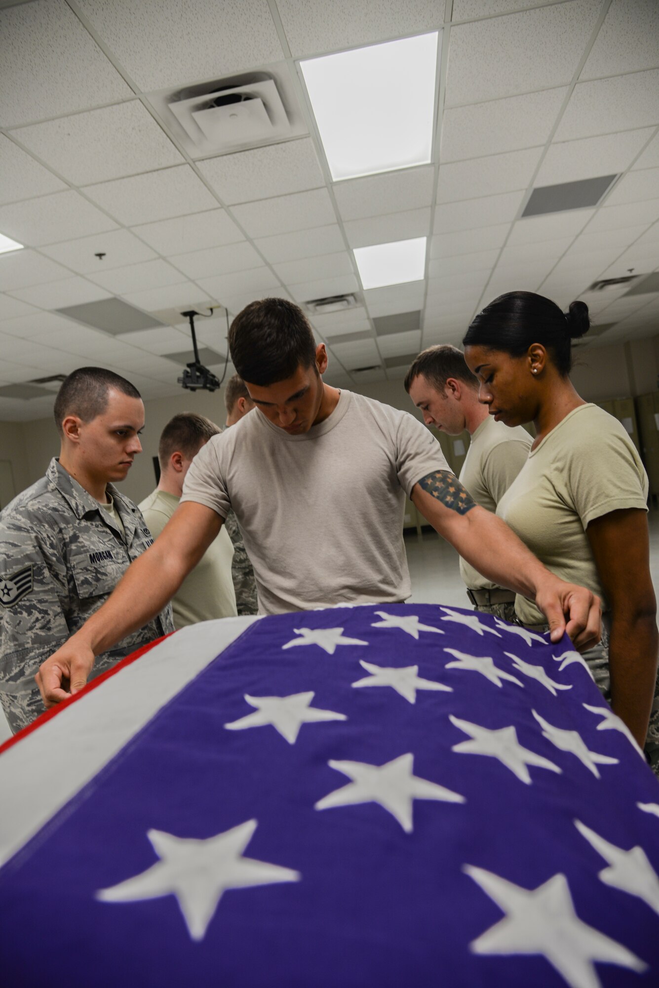 U.S. Air Force Senior Airman Justin Benito, Moody Air Force Base ceremonial guardsman drapes the flag over a casket during a retiree funeral practice at Moody, Ga., July 9, 2014. Moody’s honor guard provides military honors for veterans and retirees in Georgia and north Florida. (U.S. Air Force photo by Airman 1st Class Sandra Marrero/Released)
