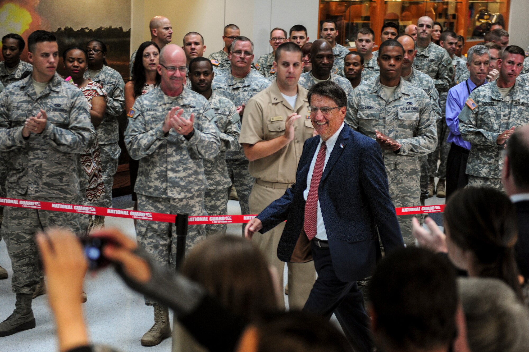 Service members welcome North Carolina Governor Pat McCrory as he prepares to sign Senate Bill 761, July 10, 2014, in Raleigh, North Carolina. McCrory signed legislature that will ensure college credits are given to students who have already completed similar training through the military. Five Airmen were selected from Seymour Johnson Air Force Base, North Carolina to attend the signing.  (U.S. Air Force photo/Airman 1st Class Brittain Crolley)