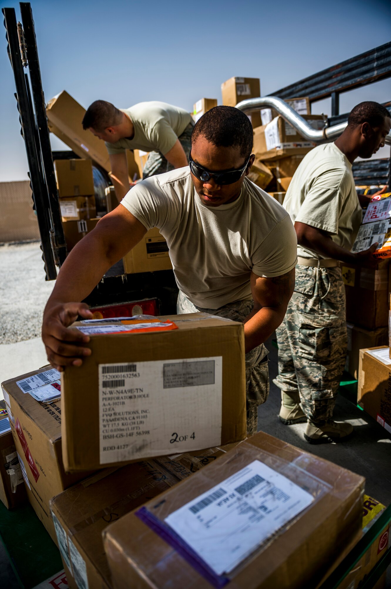 U.S. Air Force Senior Airman Adam Williams 386th Expeditionary Logistics Readiness Squadron traffic management journeyman, unloads packages shipped to the 386th at the transportation management office May 31, 2014 at an undisclosed location in Southwest Asia. Williams is deployed from the 6th LRS, MacDill Air Force Base, Florida, in support of Operation Enduring Freedom. (U.S. Air Force photo by Staff Sgt. Jeremy Bowcock)