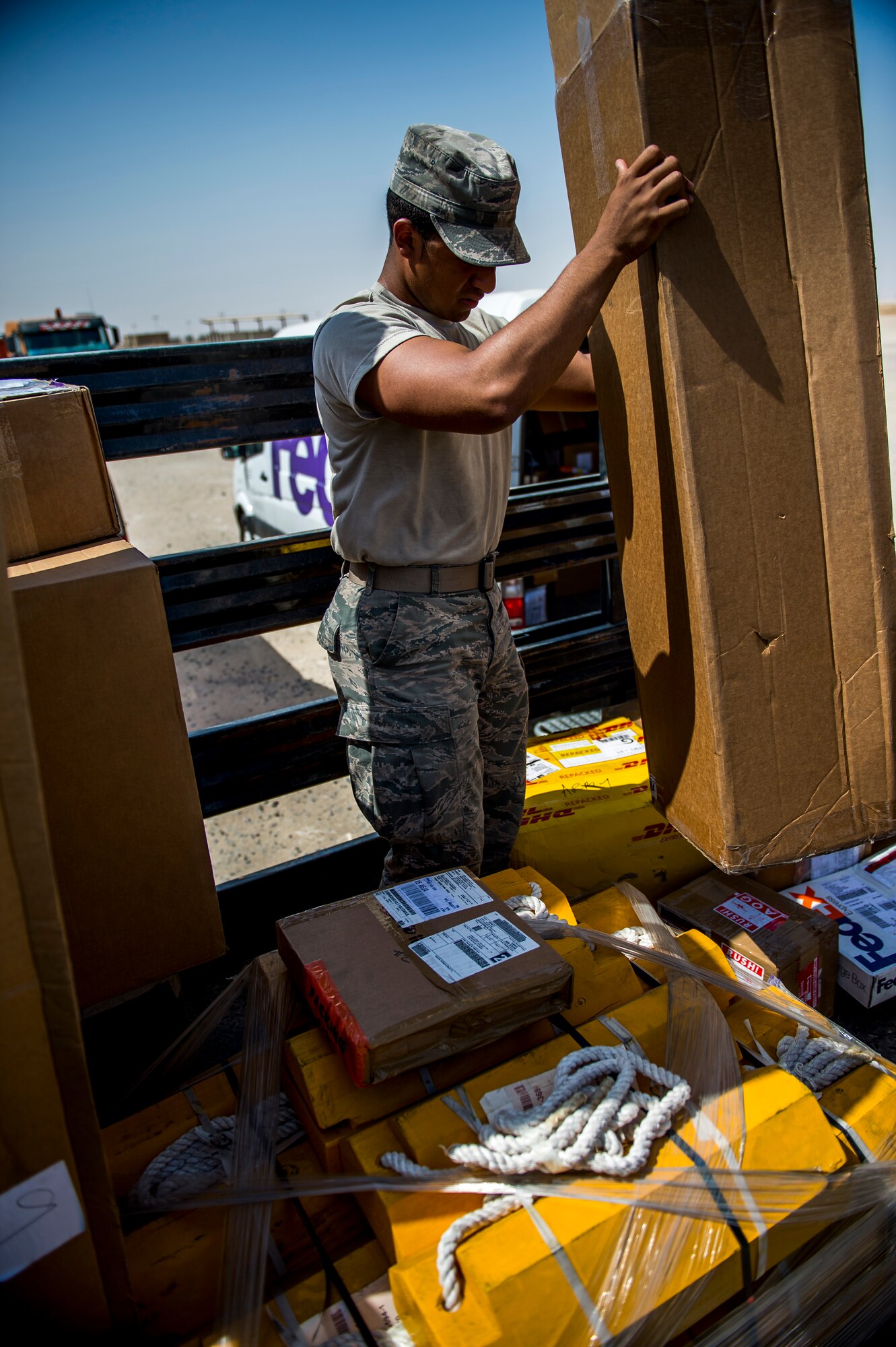 U.S. Air Force Senior Airman Christopher Daniels, 386th Expeditionary Logistics Readiness Squadron inbound cargo processor, loads packages from small package carriers into government vehicles May 31, 2014 at an undisclosed location in Southwest Asia. Daniels is deployed from the 6th LRS, MacDill Air Force Base, Florida, in support of Operation Enduring Freedom. (U.S. Air Force photo by Staff Sgt. Jeremy Bowcock)