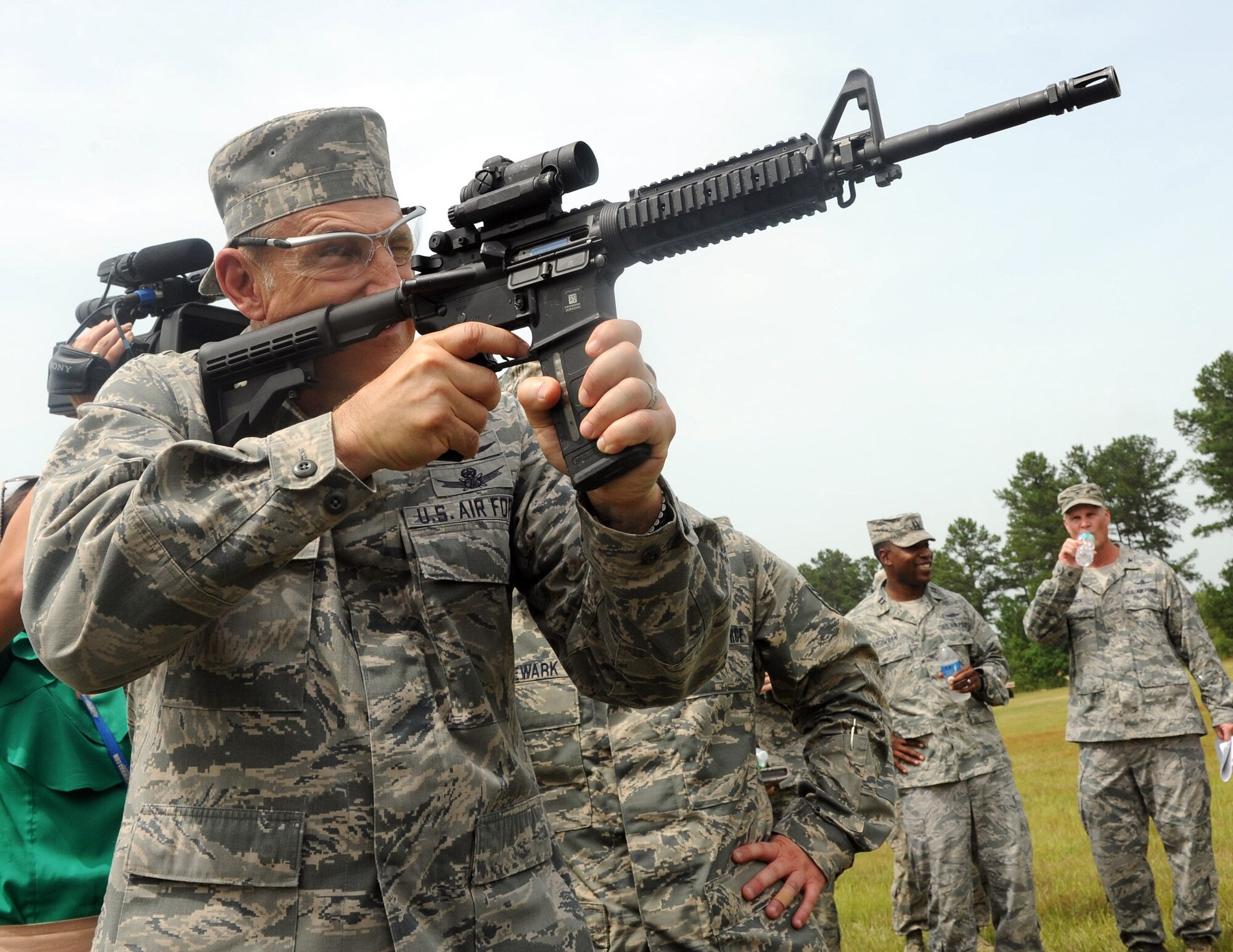 Lt. Gen. Michael Basla takes a moment during his tour to fire target practice rounds, July 2, 2014. The 5th Combat Communications Group celebrated its 50th anniversary last week with events including a shooting competition, an open house and a banquet. (U.S. Air Force photo by Tommie Horton)