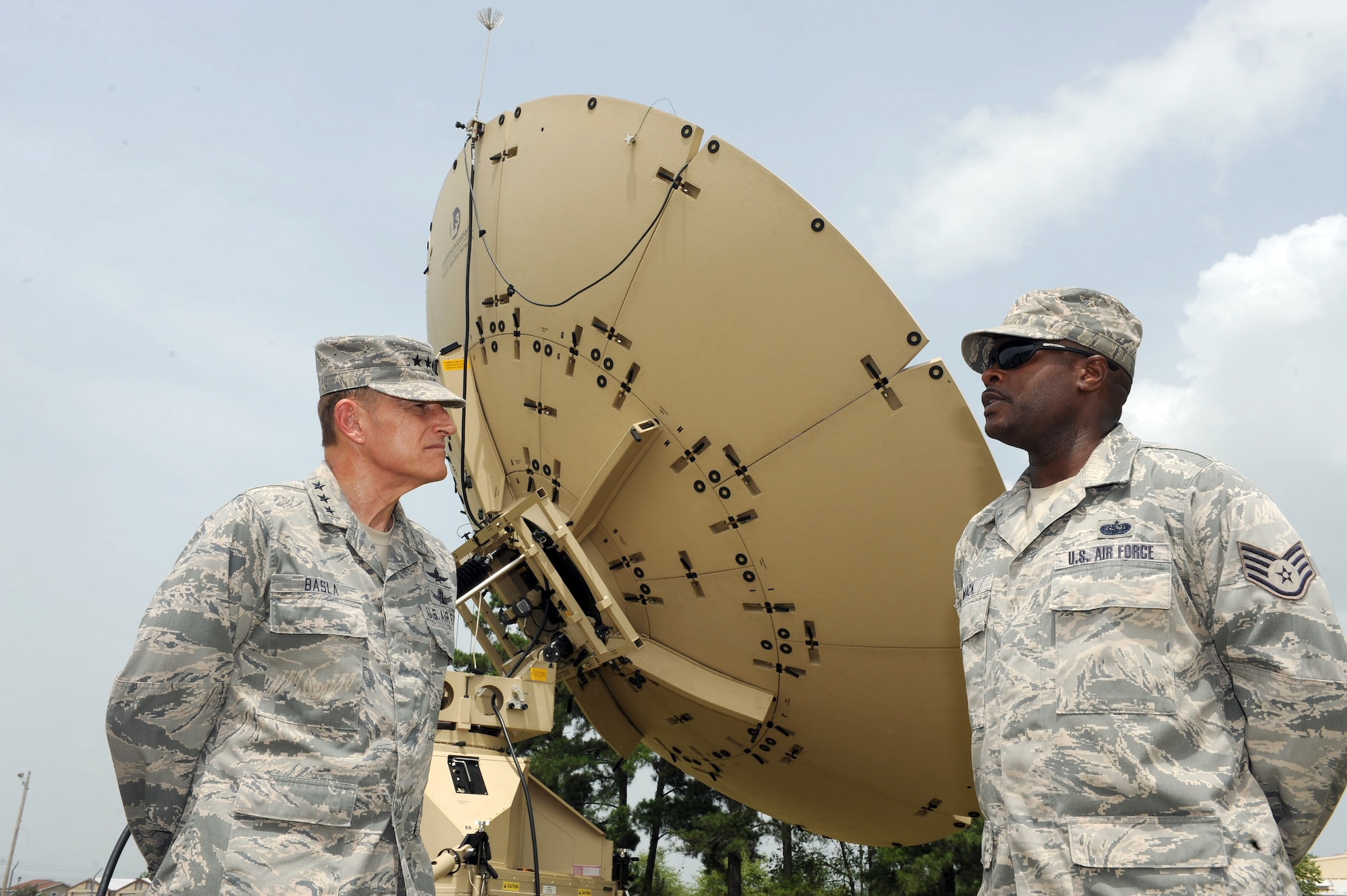 Lt. Gen. Michael Basla, Office of the Secretary of the Air Force, Information Dominance and Chief Information officer, greets Staff Sgt. Saiyd Mack, 51st Combat
Communications Squadron Radio Frequency Transmissions supervisor, during a tour of facilities July 2, 2014. (U.S. Air Force photo by Tommie Horton)