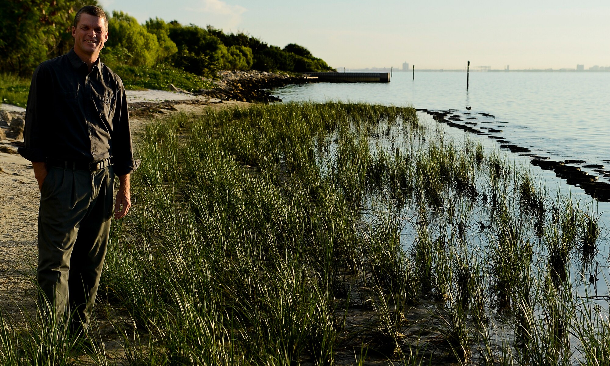Jason Kirkpatrick, 6th Civil Engineer Squadron natural resources program manager, poses for a photo along MacDill Air Force Base, Fla. shoreline July 10, 2014. Kirkpatrick is in charge of three major environmental projects, as part of the Integrated Natural Resources Management Plan, that ensures the 7.2 miles of shoreline and more than 5,000 acres of land are protected. (U.S. Air Force photo by Senior Airman Melanie Bulow-Gonterman/Released) 