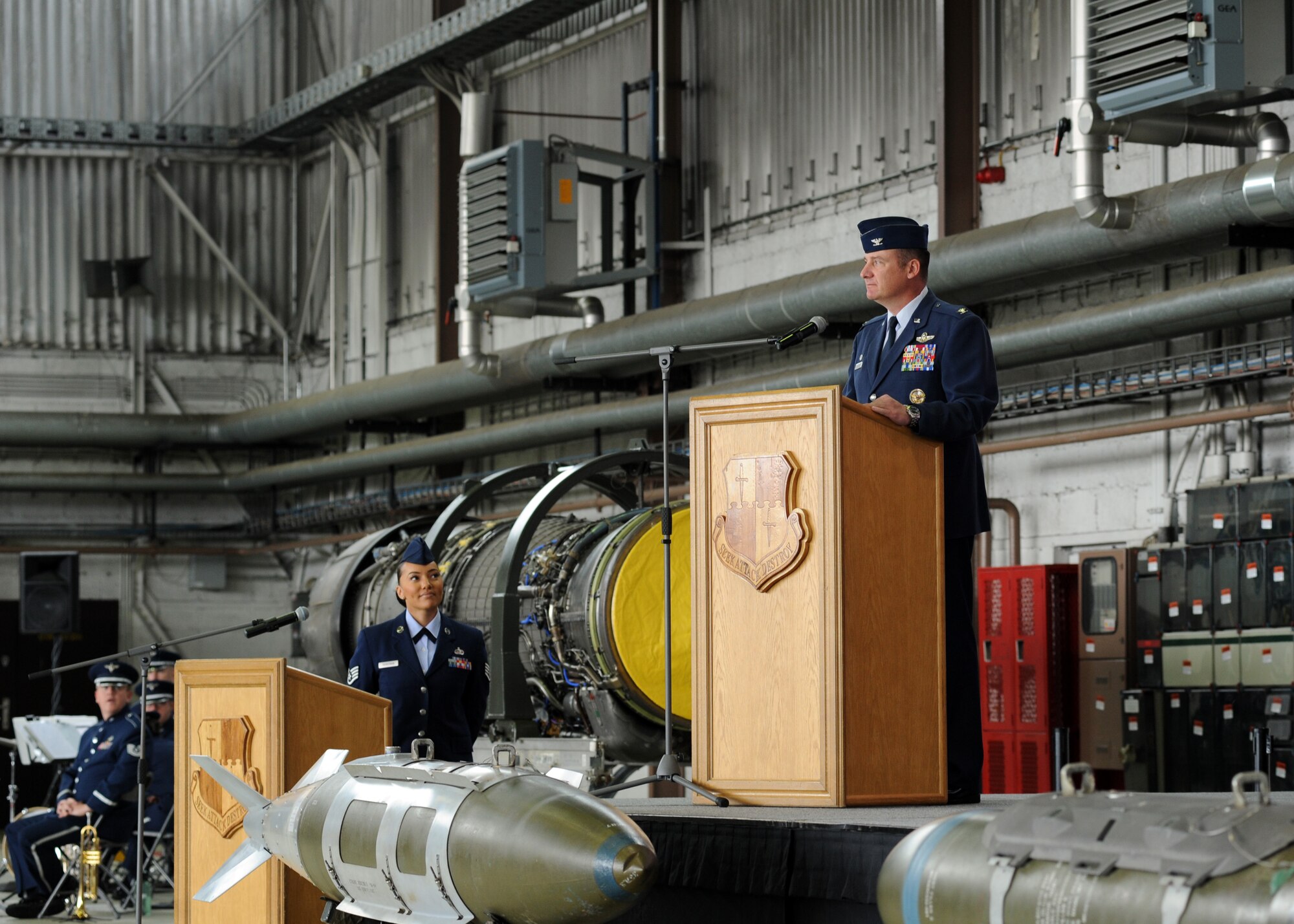 U.S. Air Force Col. Peter Bilodeau, 52nd Fighter Wing commander, prepares to address the Saber Nation during an assumption of command ceremony in Hangar 1 at Spangdahlem Air Base, Germany, July 11, 2014. An assumption of command is a military tradition that represents a formal transfer of authority and responsibility for a unit to a commanding officer. (U.S. Air Force photo by Airman 1st Class Dylan Nuckolls/Released)