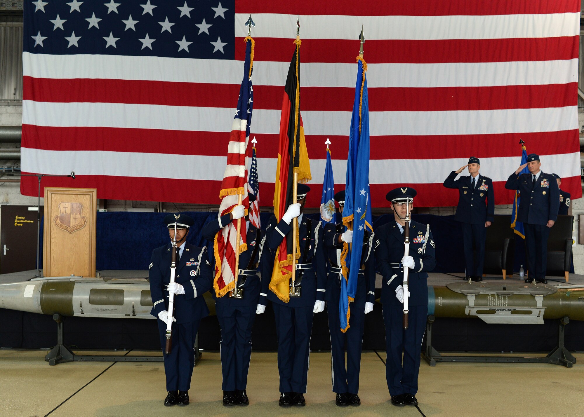 The Spangdahlem honor guard posts the colors for the national anthem during the 52nd Fighter Wing assumption of command ceremony in Hangar 1 at Spangdahlem Air Base, Germany, July 11, 2014. More than 500 Saber Airmen attended the ceremony where U.S. Air Force Col. Peter Bilodeau assumed command of the wing. (U.S. Air Force photo by Staff Sgt. Daryl Knee/Released)