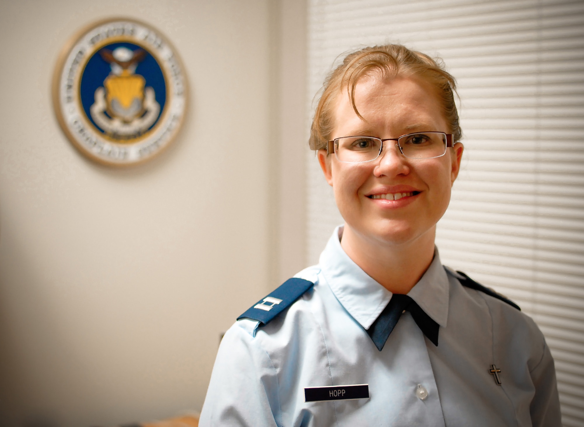 U.S. Air Force Chaplain (Capt.) Kristi L. Hopp serves as a chaplain at the 182nd Airlift Wing in Peoria, Ill., pictured May 5, 2014. Hopp received ordination as a United Methodist Church minister June 6, 2014, after completing an 8-year process of education and evaluation. She first became interested in the military during a Veterans Affairs hospital internship. “The stressors that we all are under in the Guard and being deployed are different. And yeah, sometimes we come back wounded, but then that’s kind of what war does,” she said. “It might not always wound us on the outside, but it can wound us on the inside. And so, it’s a very rewarding ministry to be able to serve here.” (U.S. Air National Guard photo illustration by Staff Sgt. Lealan Buehrer/Released)