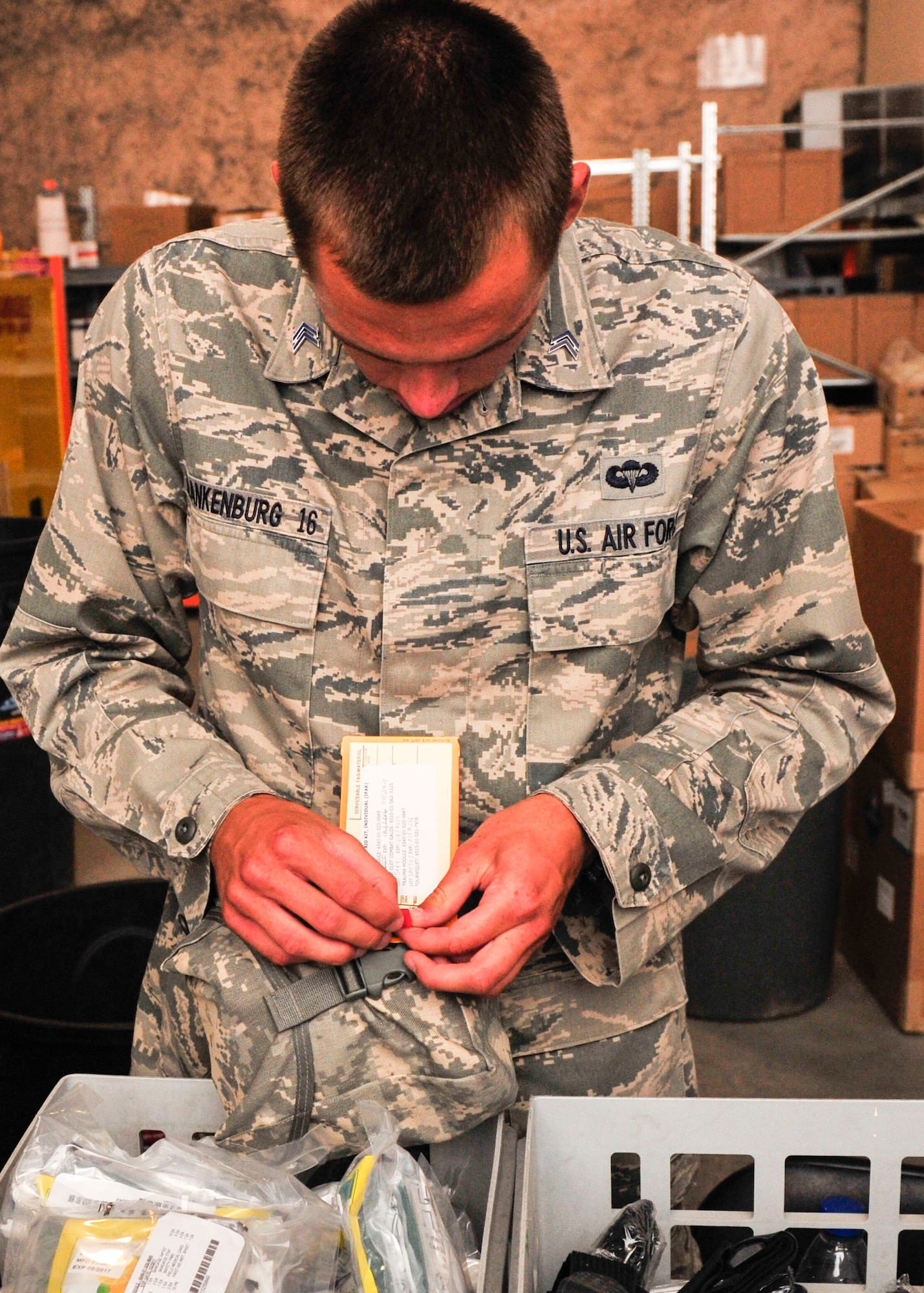 U.S. Air Force Academy Cadet Mankenburg, tags completed Individual First Aid Kit at Al Udeid Air Base, Qatar, June 30, 2014 during his visit as part of the Operation Air Force program. In this program, cadets in their second year at the academy visit an Air Force installation to expose them to the AF way of life. During their three weeks here, the cadets visited various squadrons to get hands-on experience with the jobs performed therein. (U.S. Air Force photo by Senior Airman Colin Cates) 