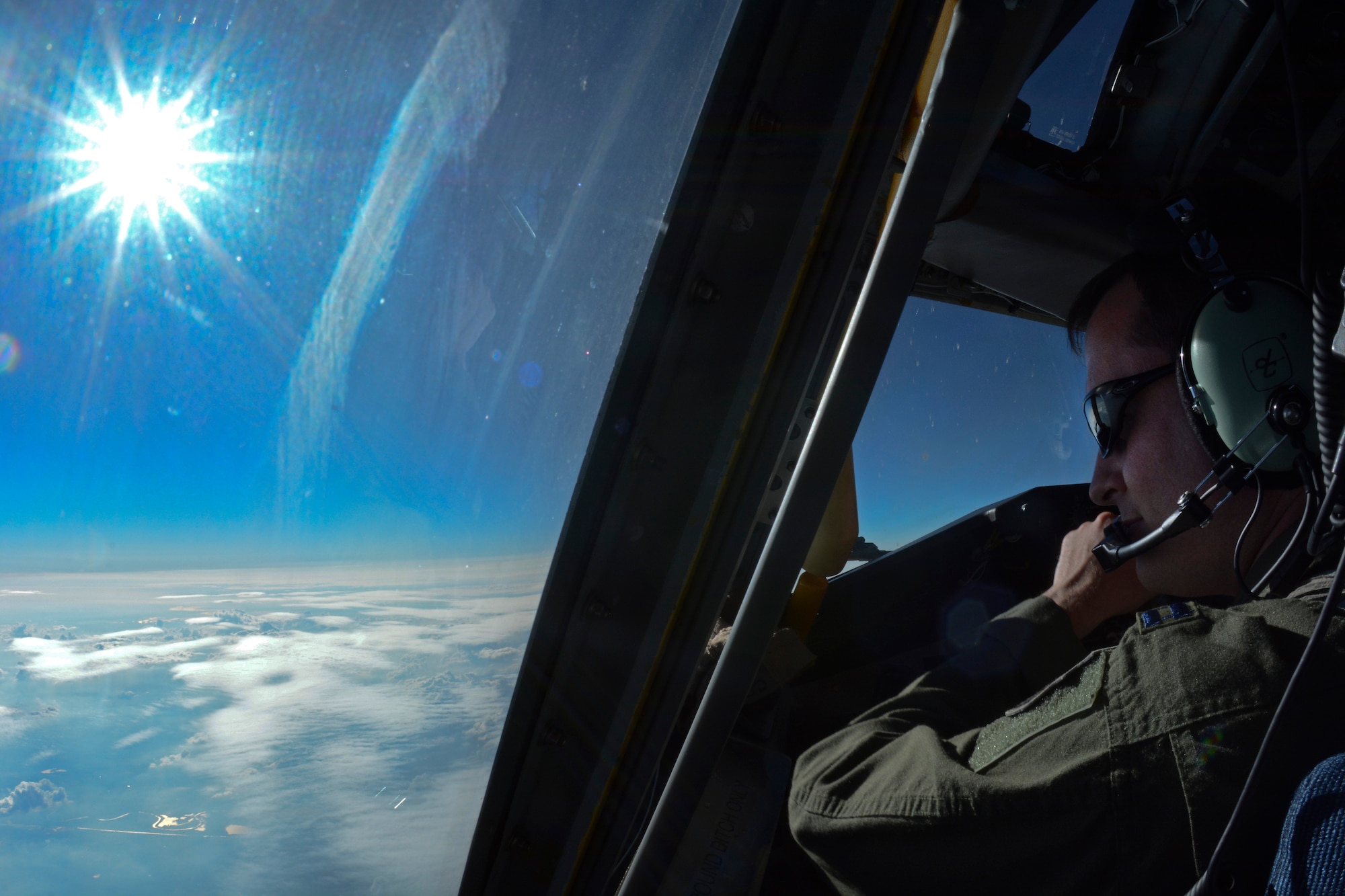 U.S. Air Force Capt. David Clark, 351st Air Refueling Squadron pilot from St. Clair Shores, Mich., looks out a window while flying a KC-135 Stratotanker June 24, 2014 over Germany. Clark and his crew supported three missions in one day, air-to-air refueling, space-available travel and aeromedical evacuation training. (U.S. Air Force photo/Senior Airman Micaiah Anthony/Released)