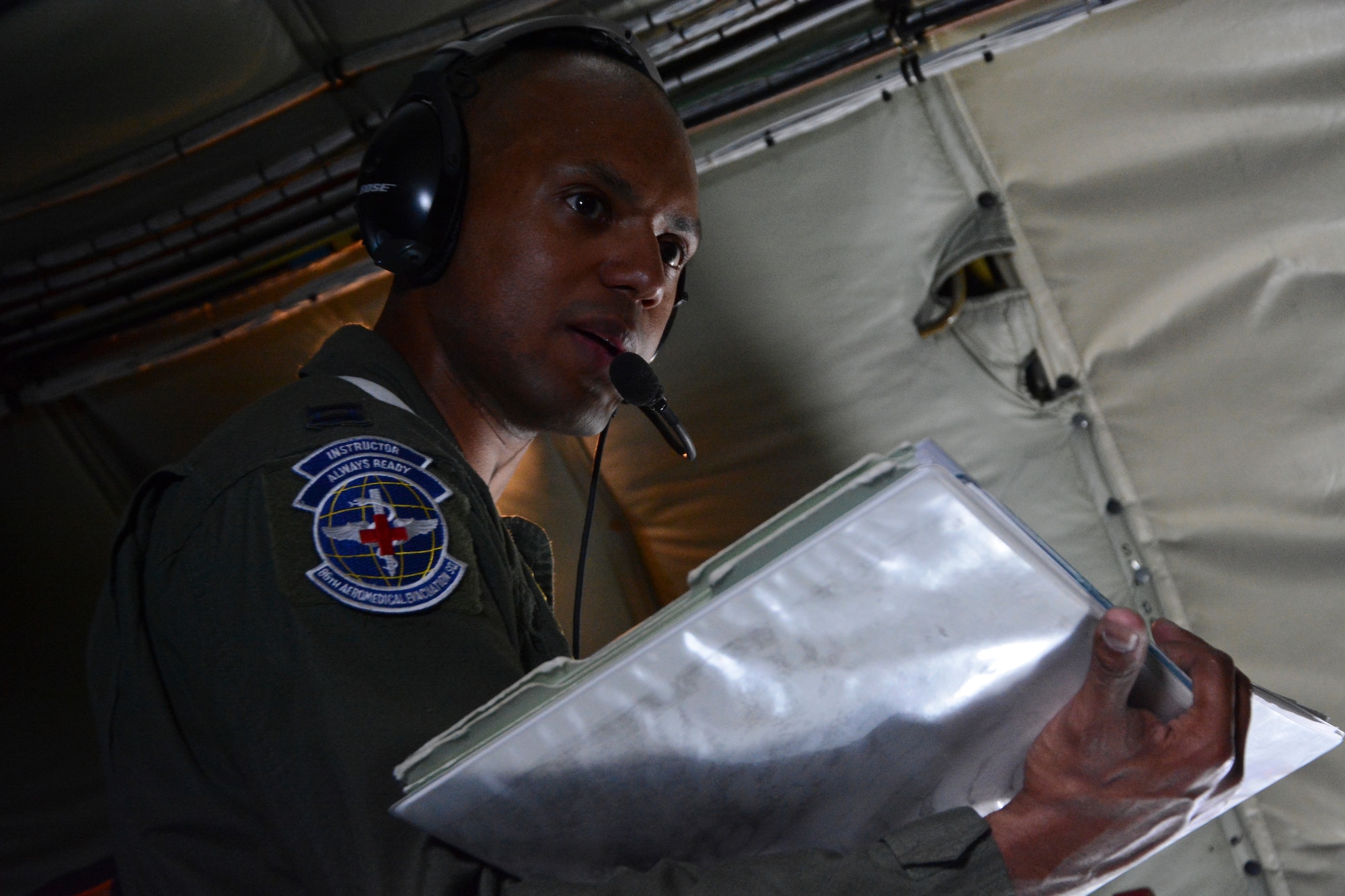 U.S. Air Force Capt. Adrian Rodriguez, 86th Aeromedical Evacuation Squadron, Ramstein Air Base, German, flight nurse from Atlanta, discusses in-flight medical emergency scenarios June 24, 2014, on a KC-135 Stratotanker over Germany. Along with scenarios, the crew talked about the aircraft electrical and oxygen systems and emergency exit locations. (U.S. Air Force photo/Senior Airman Micaiah Anthony/Released) 