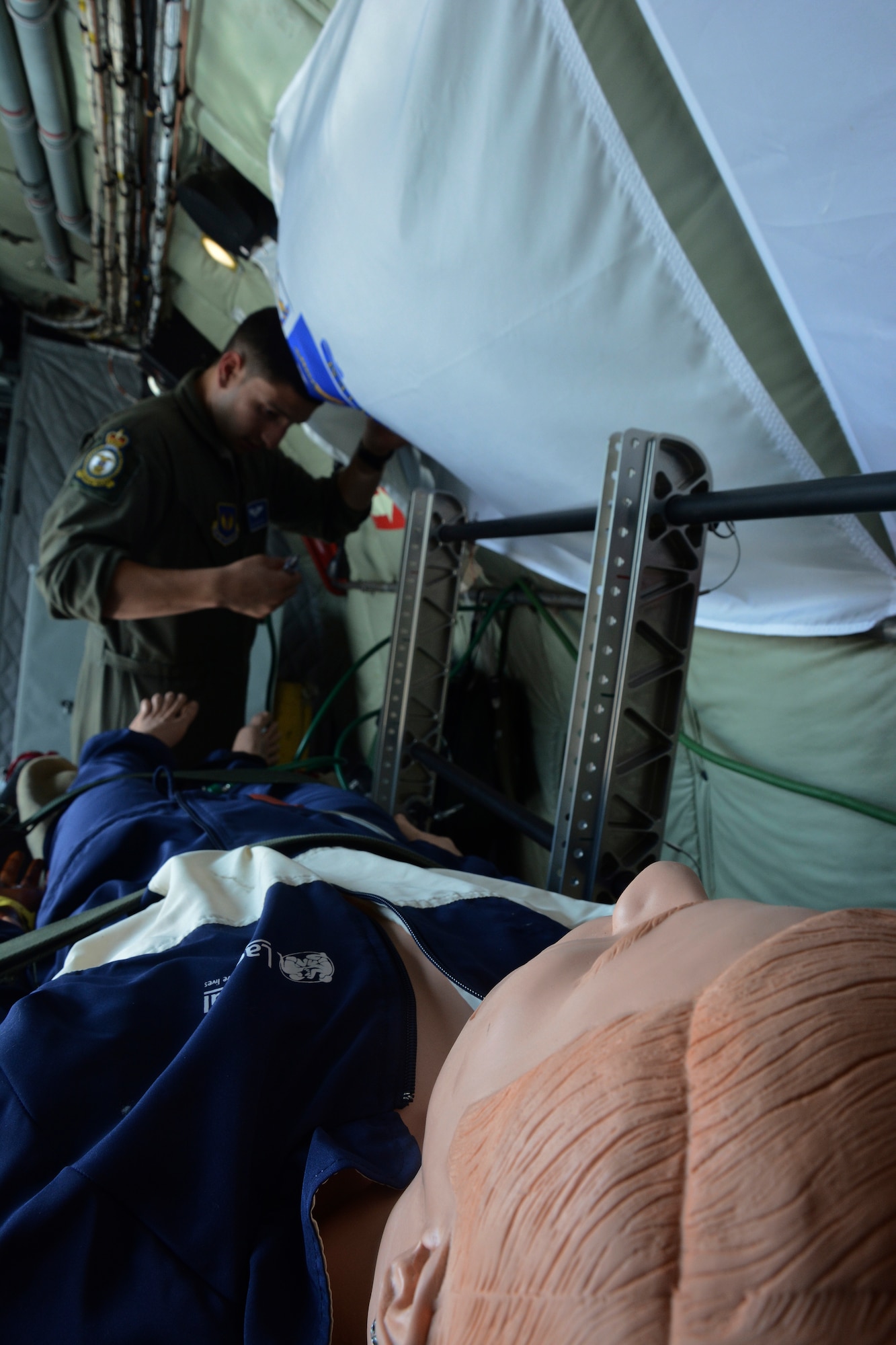 U.S. Air Force Staff Sgt. Alexander Ortiz, 86th Aeromedical Evacuation Squadron, Ramstein Air Base, Germany, medical technician from Albuquerque, N.M., disassembles medical equipment June 24, 2014, on a KC-135 Stratotanker on Ramstein AB. Airmen from the 86th AES went over in-flight emergency scenarios and learned about the aircraft systems to improve familiarity. (U.S. Air Force photo/Senior Airman Micaiah Anthony/Released)