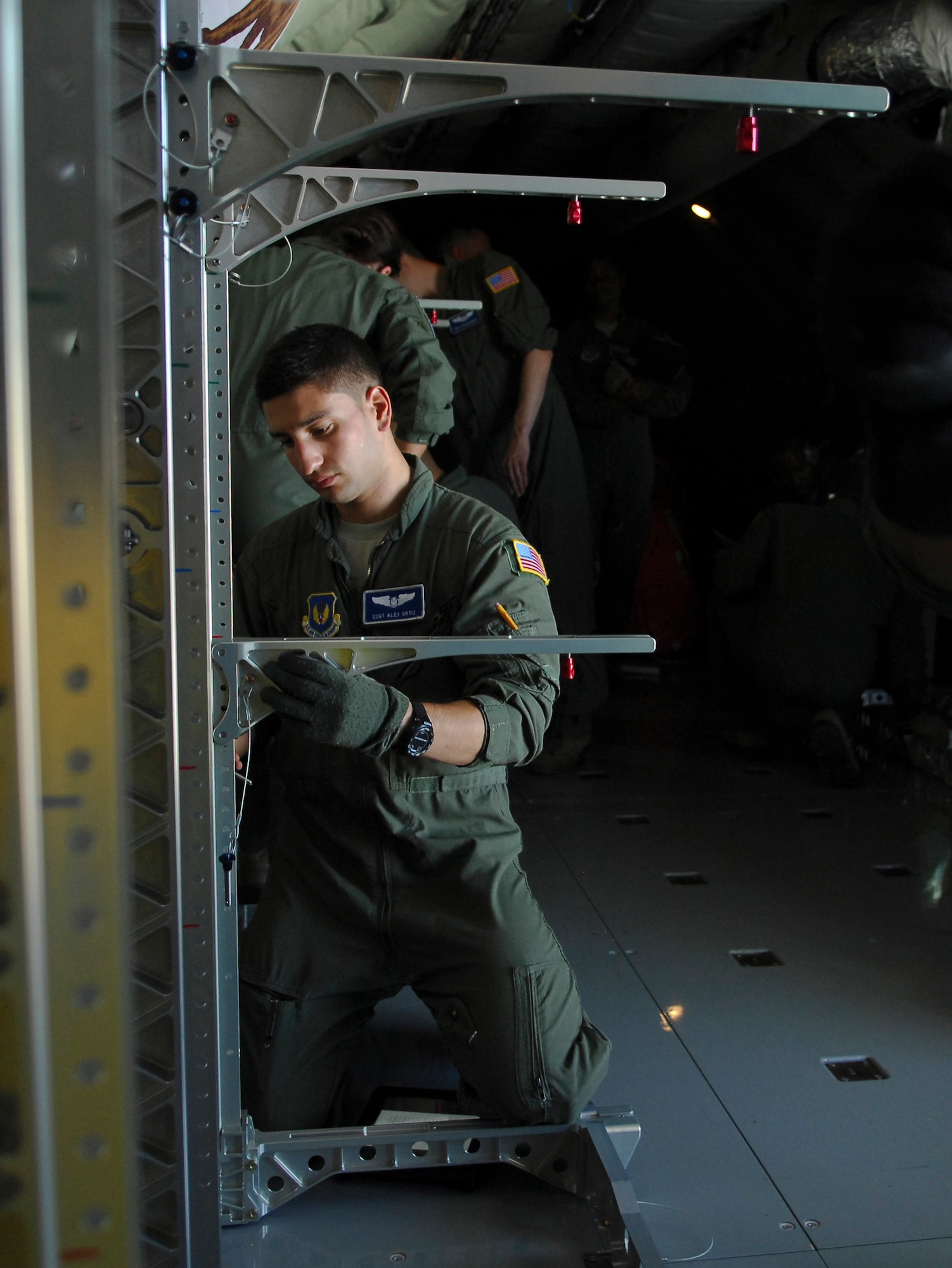 U.S. Air Force Staff Sgt. Alexander Ortiz, 86th Aeromedical Evacuation Squadron, Ramstein Air Base, Germany, medical technician from Albuquerque, N.M., assembles a stanchion litter system June 24, 2014, on a 100th Air Refueling Wing KC-135 Stratotanker at Ramstein AB. The litter system is used to safely secure patients and equipment on aircraft while in flight. (U.S. Air Force photo/Senior Airman Micaiah Anthony/Released)