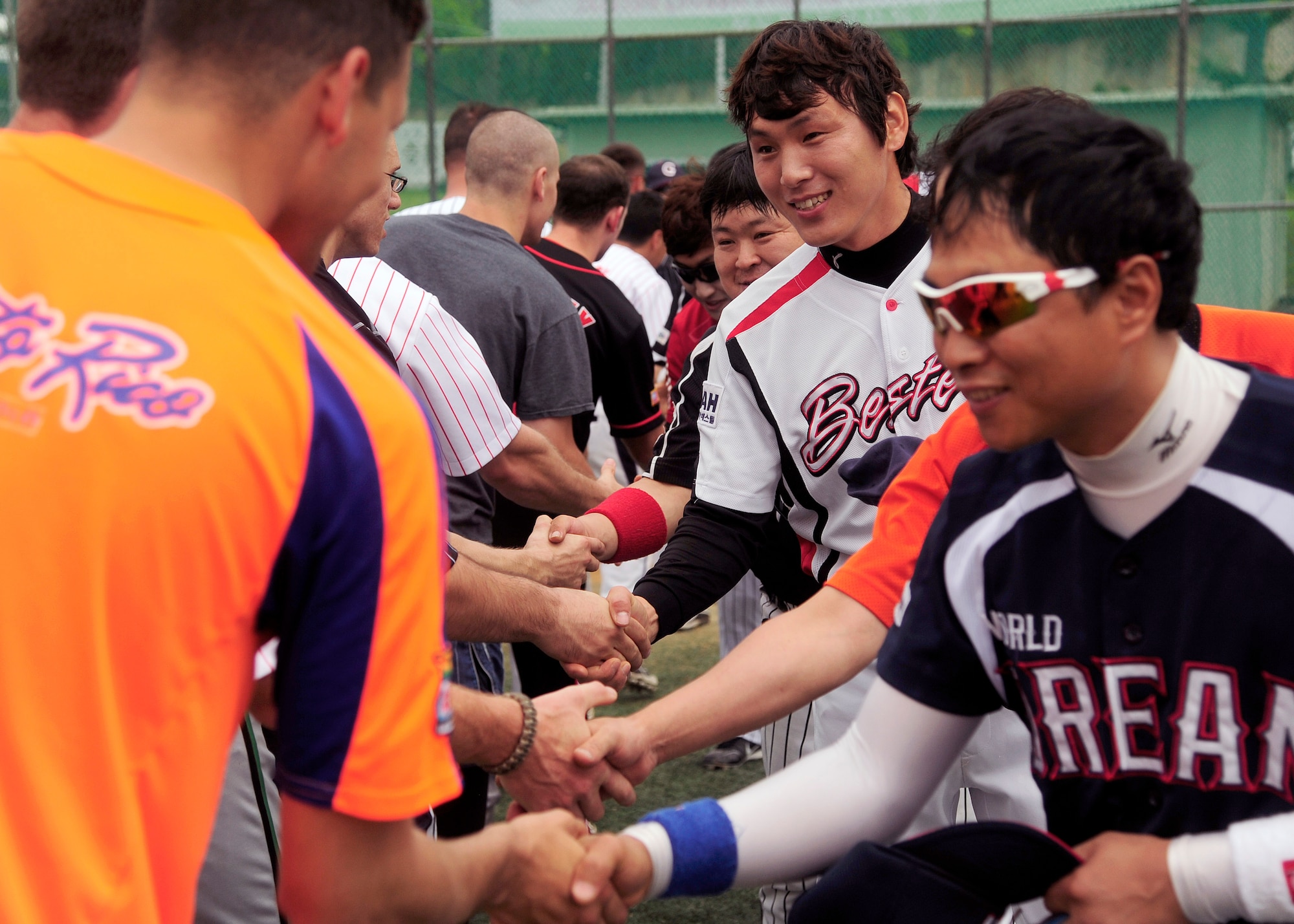 Baseball players from Kunsan Air Base and Gunsan City shake hands before they play a game at the Kunsan Sang High School in Munhwadong, Gunsan City, Republic of Korea, June 21, 2014. The game highlights the lasting partnership on the peninsula and to experience each other’s cultures as they operate as a team. (U.S. Air Force photo by Senior Airman Taylor Curry/Released)
