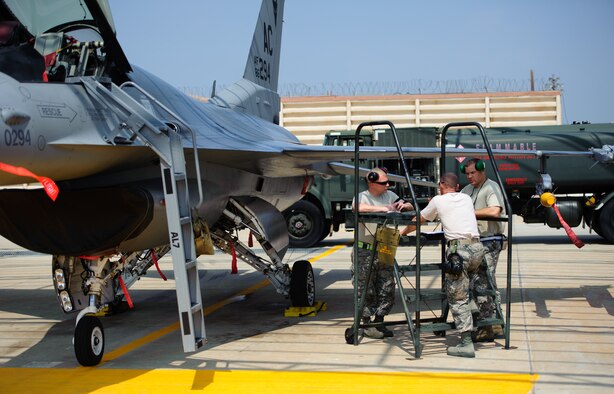 Airmen from the New Jersey Air National Guard discuss a maintenance plan to prepare their F-16 Fighting Falcon for a training sortie at Kunsan Air Base, Republic of Korea, June 11, 2014. The Airmen are part of a Theater Security Package designed to deploy additional fighters, tankers and Airmen to locations across the Pacific reinforcing the U.S. commitment to its allies. (U.S. Air Force photo by Senior Airman Armando A. Schwier-Morales/Released)