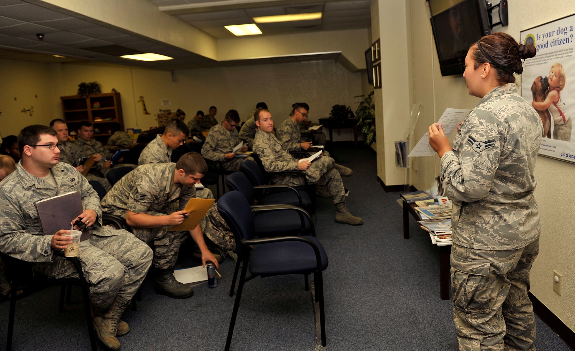 U.S. Air Force Airman 1st Class Gloria Bumgardner-Zepeda, 18th Force Support Squadron customer service technician, explains the procedure of in-processing on Kadena Air Base, Japan, July 11, 2014. All newcomers must in-process at the military personnel section first prior to attending Base Newcomer's Orientation. They also must visit the 18th Security Forces Squadron Pass and Registration section to get registered in the Defense Biometric Identification System within 72 hours of arrival on station. (U.S. Air Force photo by Naoto Anazawa/Released)