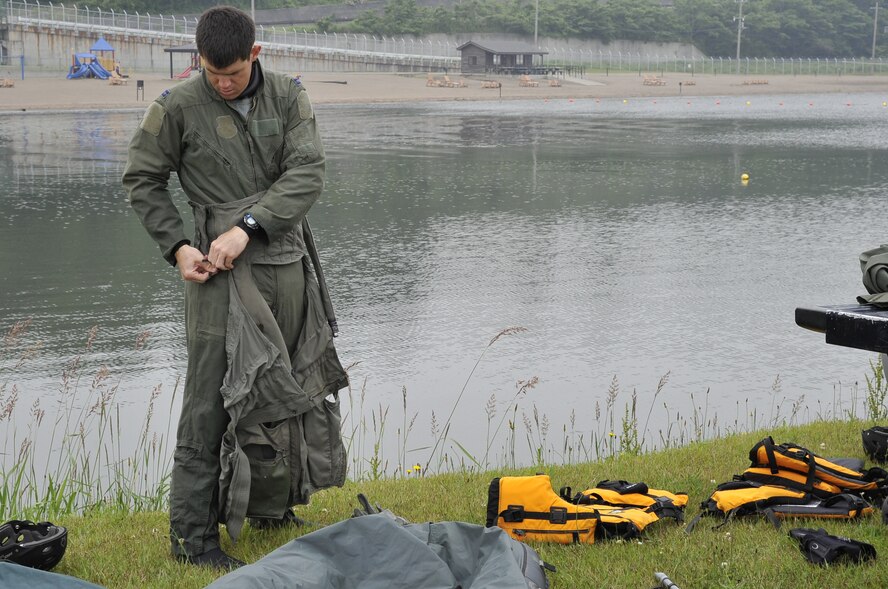 U.S. Air Force Capt. Garrett Omohundro, 14th Fighter Squadron A-Flight commander, participates in a Survival Evasion Resistance and Escape water survival course at Misawa Air Base, Japan, June 18, 2014. As part of SERE training, pilots are educated on emergency water-landing hazards, as well as how to survive in enemy territory. (Air Force photo/Airman 1st Class Patrick S. Ciccarone)