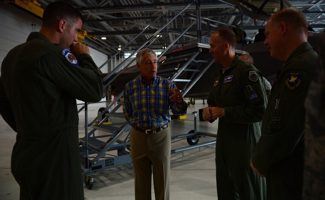 Defense Secretary Chuck Hagel chats with Air Force Brig. Gen. David A. Harris, far right, commander of the 96th Test Wing, Air Force Col. Todd Canterbury, right, commander of the 33rd Fighter Wing, and Air Force Lt. Col. Matt Renbarger, left, commander of the 58th Fighter Squadron, on Eglin Air Force Base, Fla., July 10, 2014. 