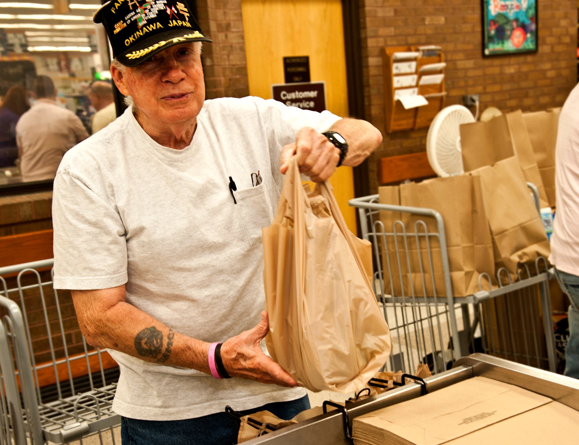 Don Magers, retired Marine, bags groceries at the Whiteman Commissary June, 25, 2014. Magers had his 80th birthday this past Independence Day. (U.S. Air Force photo by Senior Airman Daniel Phelps/Released)