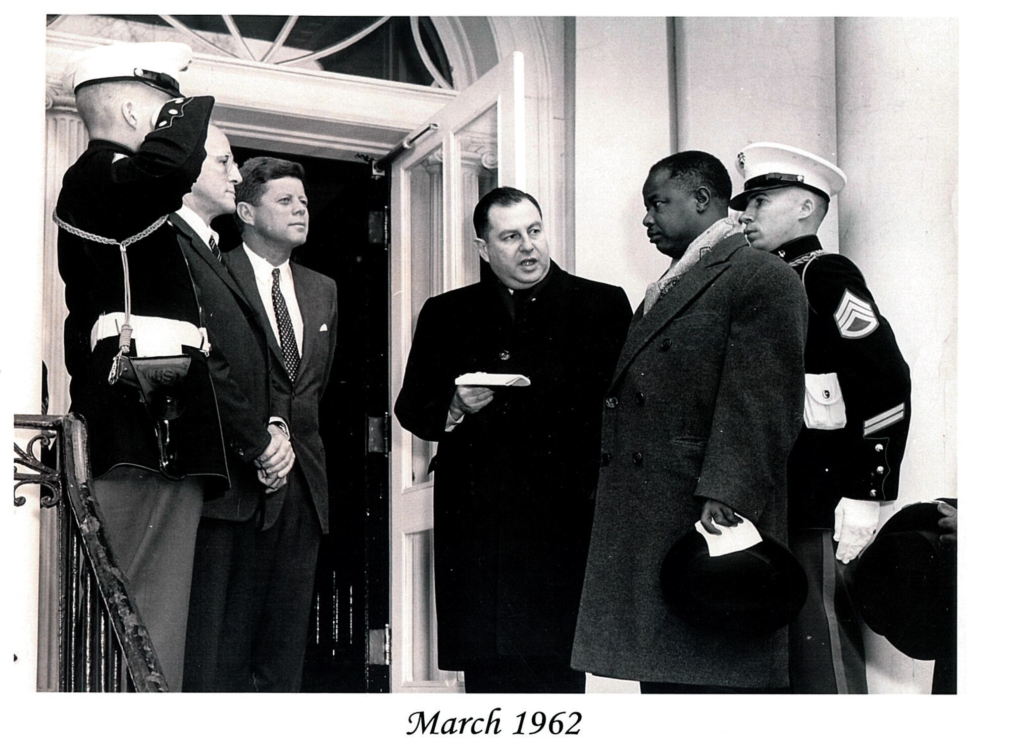 Don Magers (far right Marine) stands guard for President John F. Kennedy during a meeting. Magers, a bagger at the Whiteman Air Force Base comissary, had his 80th birthday on July 4, 2014. (U.S. Air Force/courtesy photo)