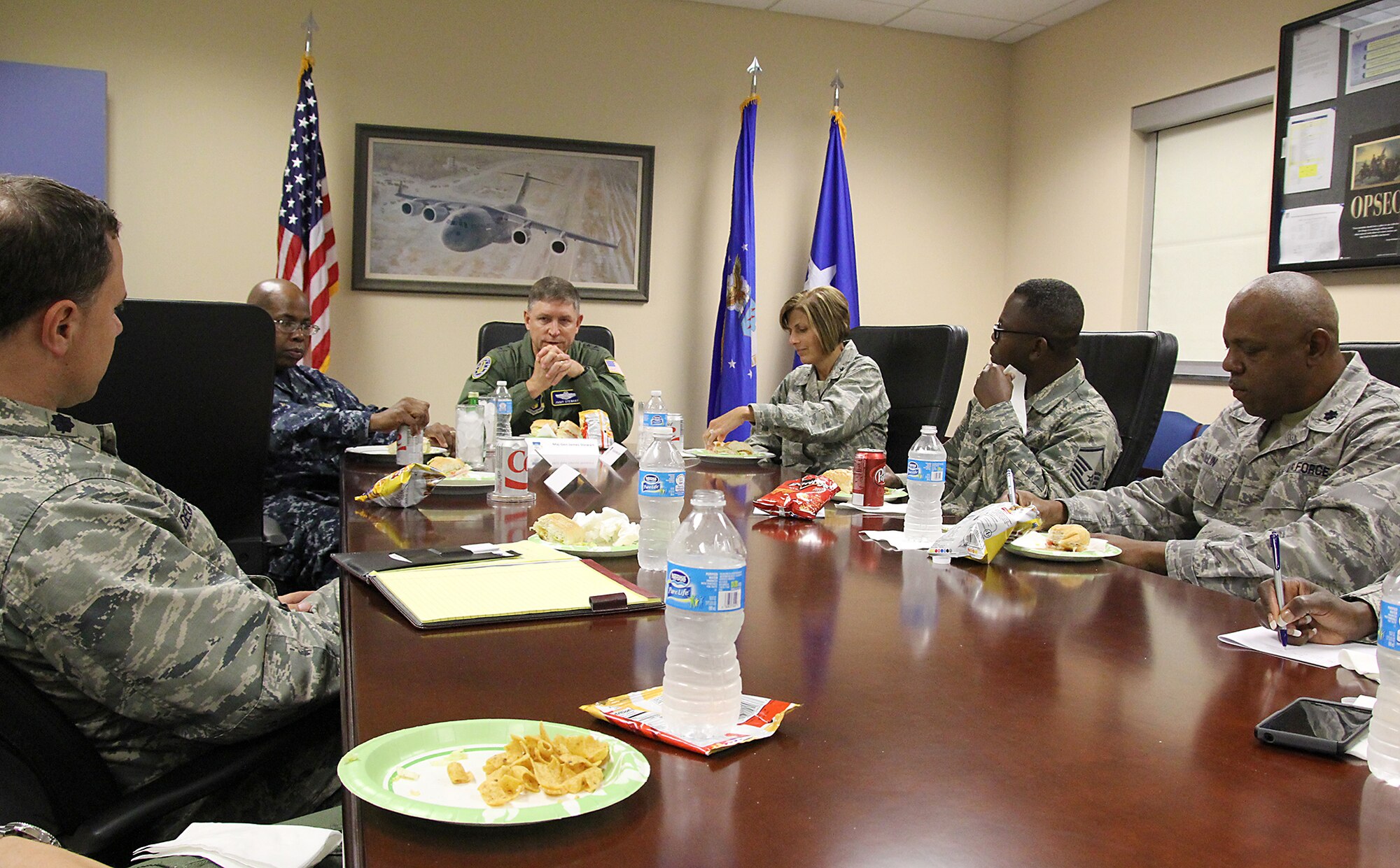 During a 315th Airlift Wing Human Resources Development Committee lunch and learn event July 12, Maj. Gen. James N. Stewart, military executive officer for the Reserve Forces Policy Board, Office of the Secretary of Defense, tells a group of about 30 wing members that he started his Air Force career here at Joint Base Charleston. "It's always a pleasure to come back home." Stewart spent 10 of his 37 years here in the Operations Group. In this photo  Brig. Gen. Kimberly A. Crider is the Mobilization Assistant to the Chief, Information Dominance and Chief Information Officer, Office of the Secretary of the Air Force and Rear Adm. Eric Young, deputy chief of Navy Reserve flank Stewart. (U.S. Air Force photo / Michael Dukes)
