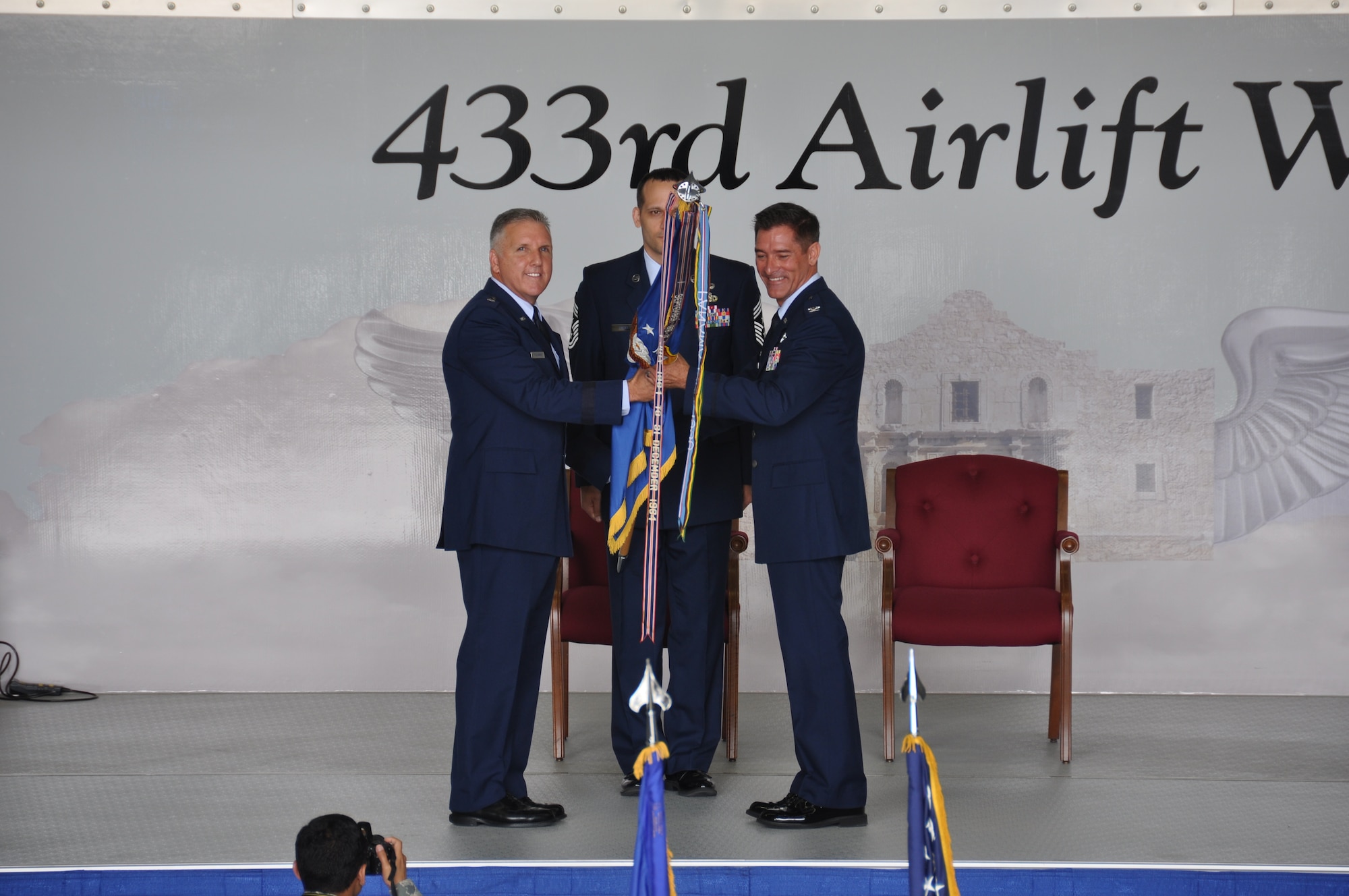 Brig. Gen. John C. Flournoy, Jr. (left), 4th Air Force commander, presents command of the 433rd Airlift Wing to Col. William W. Whittenberger, Jr. (right) at Joint Base San Antonio-Lackland, Texas, July 12, 2014. (U.S. Air Force photo by Tech Sgt. Carlos J. Trevino)
