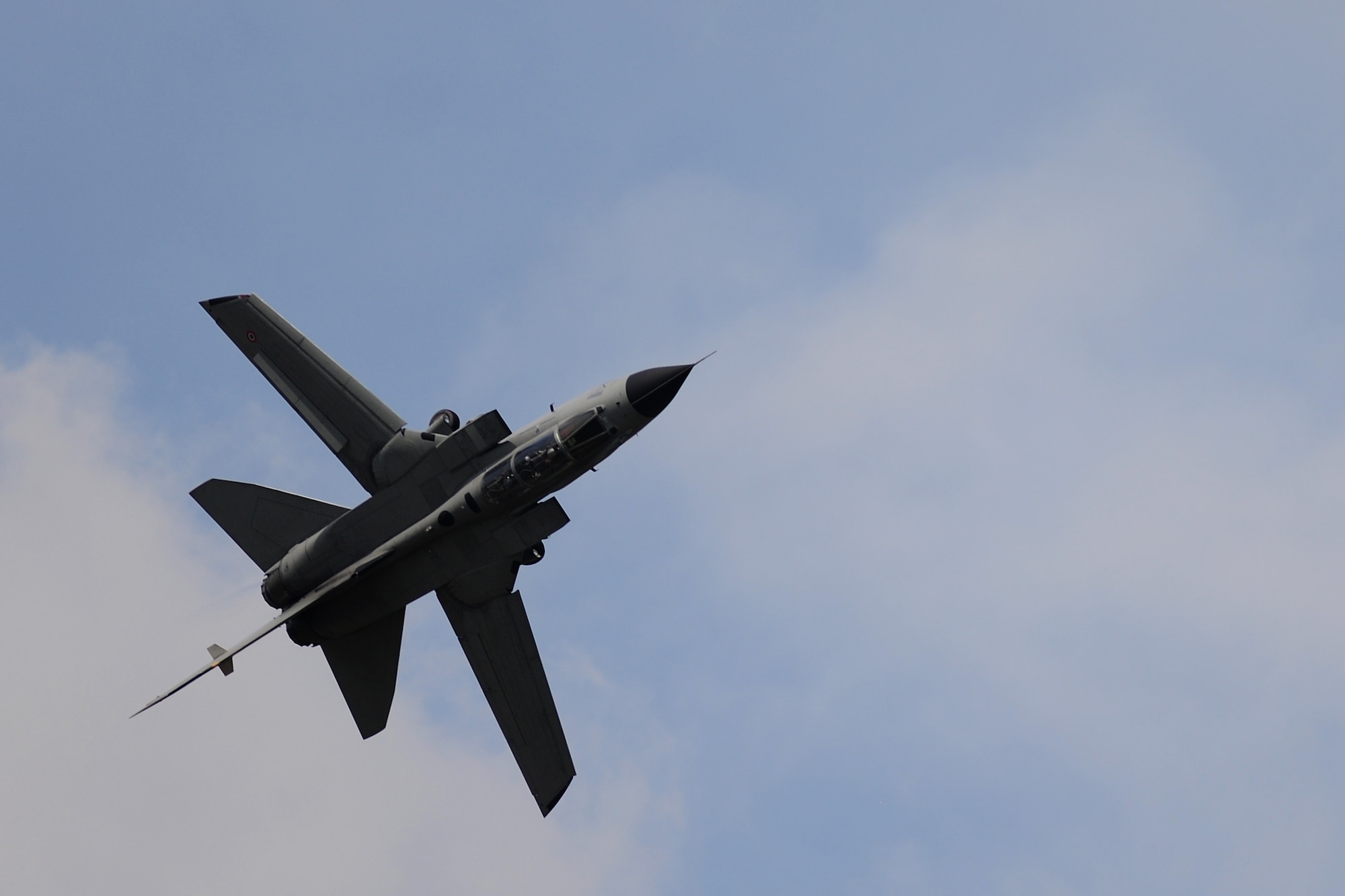An Italian Air Force A-200 Tornado completes a barrel roll in the skies above RAF Fairford, United Kingdom, during the 2014 Royal International Air Tattoo, July 12, 2014. The Tornado is a part of the 311th Flight Test Squadron. (U.S. Air Force photo by Staff Sgt. Jarad A. Denton/Released) 